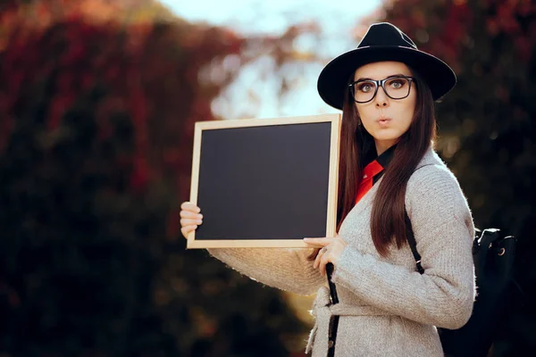 Überraschte Studentin hält ein Tafel-Schild in der Hand — Stockfoto