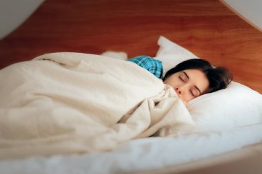 Woman in pajamas sleeping in bedroom clipart