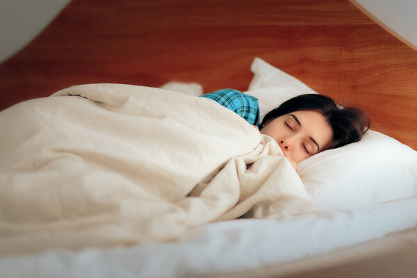 Woman in pajamas sleeping in bedroom