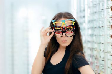Komik kadın birçok Gözlük çerçeveleri optik deposunda çalışıyor