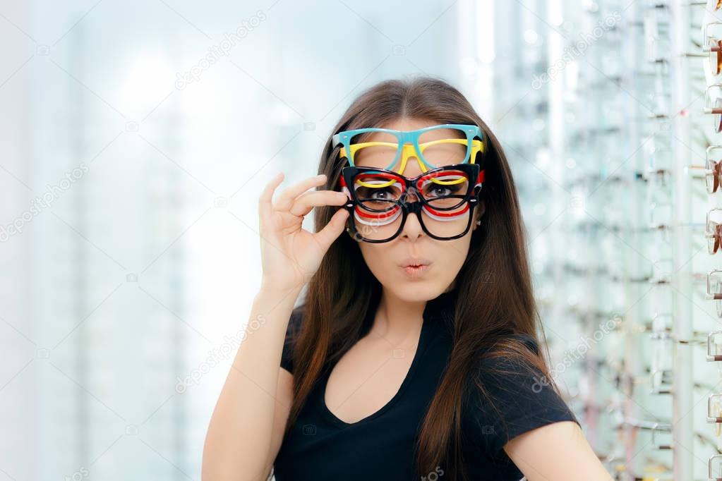 Funny Woman Trying Many Eyeglasses Frames in Optical Store