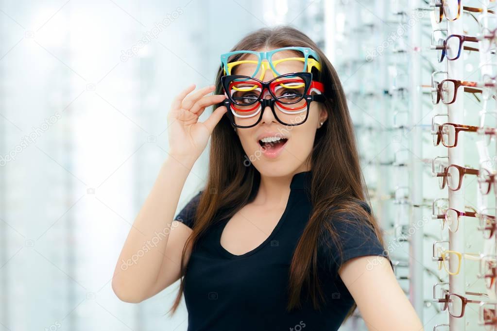 Funny Woman Trying Many Eyeglasses Frames in Optical Store