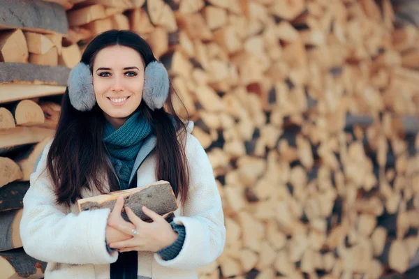 Smiling Girl in front of Fire Wood Stack Ready for Winter — стоковое фото