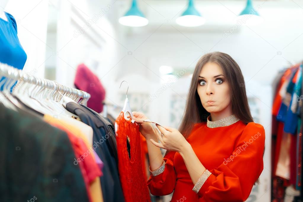 Surprised  Woman Checking Price Tag on a Dress in Sale Season