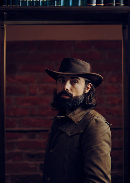 Handsome Man Wearing Cowboy hat in Western Style Portrait