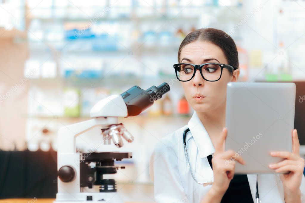 Scientist with Microscope and Pc Tablet doing Research Study 