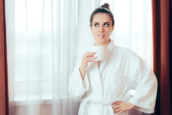 Woman in Bathrobe Starting Morning with a Cup of Coffee