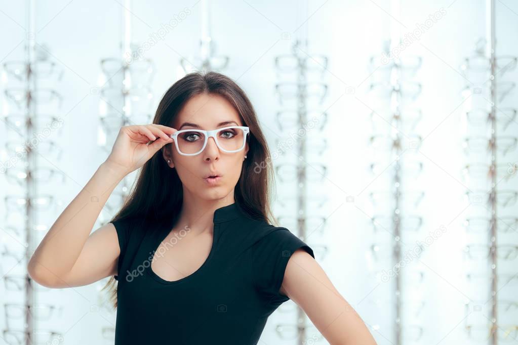 Funny Girl Looking for New Eyeglasses in Optical Store