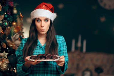 Woman Holding a Tray of Cookies Waiting for Santa Claus clipart