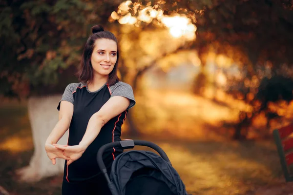 Woman Stretching Park Next Baby Stroller — 스톡 사진