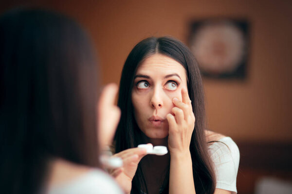 Woman Putting On Contact Lenses Getting Ready to Go Out