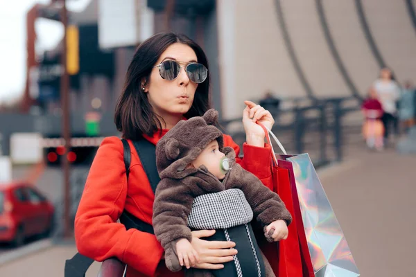 Tired Mom Carrying Baby While Shopping for Presents