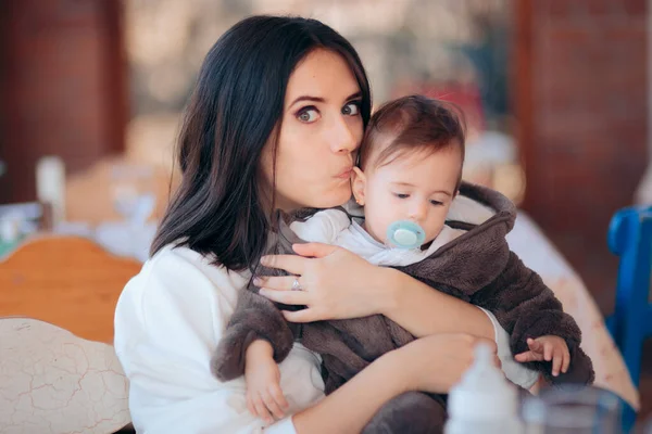 Loving Mom Kissing Cute Baby Sitting Table — Stock Photo, Image