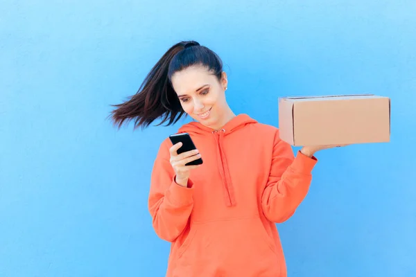 Woman Checking Her Smartphone Holding Delivery Parcel Box — Stock Photo, Image