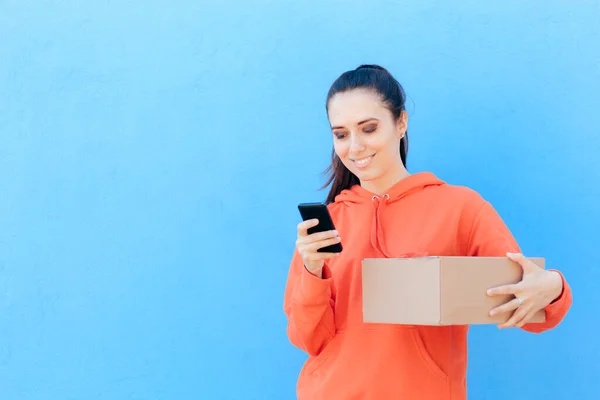 Woman Checking Her Smartphone Holding Delivery Parcel Box — Stock Photo, Image