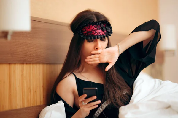 Unhappy Woman Wearing Sleep Mask Texting Smartphone — Stock Photo, Image