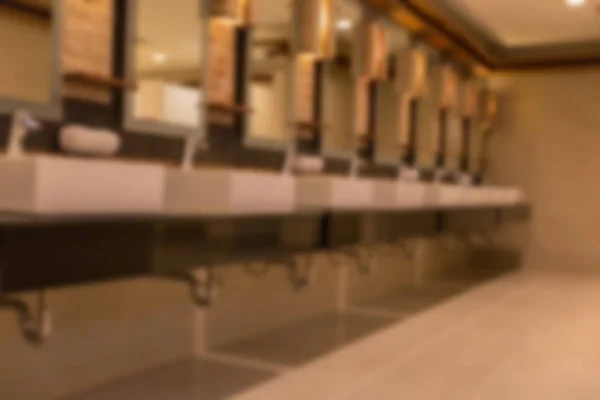 Blurred background of faucet and sink in public restroom toilet — Stock Photo, Image