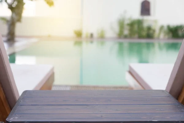 wood table and pool chair for resting and relaxing at swimming p