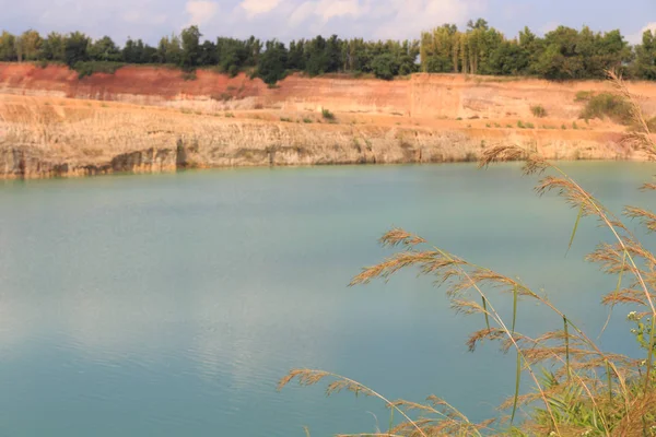 Orange valley hill and green water pond lake — стоковое фото