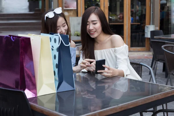 スマート フォンとカラフルなショッピング バッグのと幸せなアジア女 — ストック写真