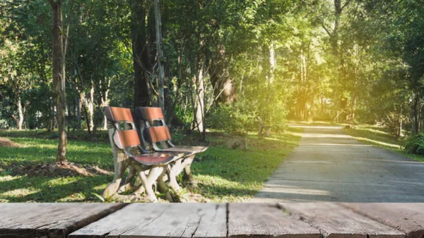 Blur image of wood bench for relaxing beside walkway in the park — Stock Photo, Image