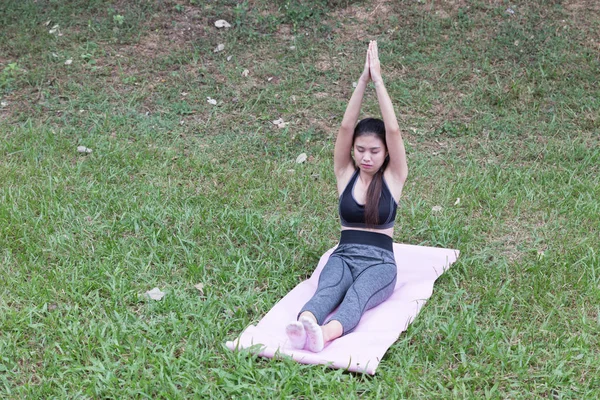 Young woman practicing yoga exercises outdoor in park,  relax in — Stock Photo, Image