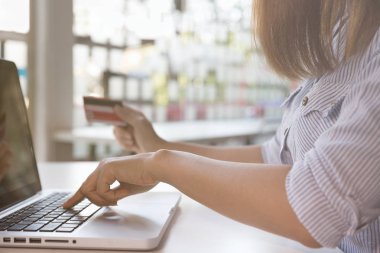 kredi kartı ile online shoppi için dizüstü bilgisayar tutan kadın