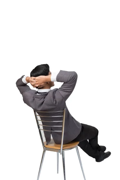 Задний вид делового человека в сером костюме сидя и расслабляясь — стоковое фото