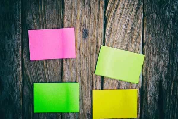 Flat lay of office supplies - colorful sticky notes on wooden bo — Stock Photo, Image