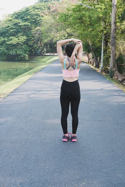 Female sport fitness runner getting ready for jogging outdoors o