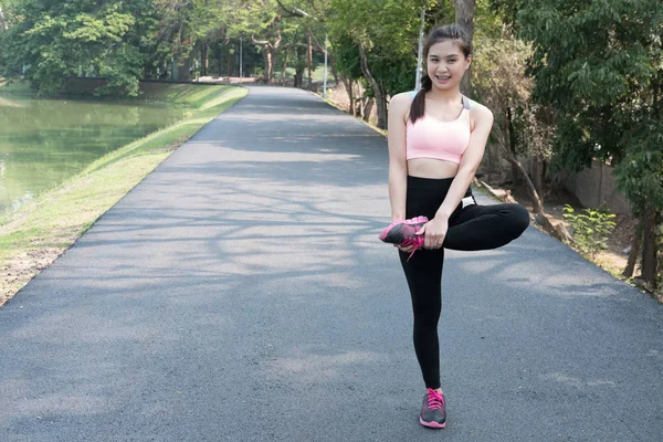 Female sport fitness runner getting ready for jogging outdoors o