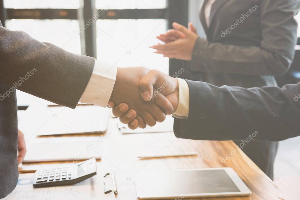 Business people shaking hands after finishing up a meeting. Two 