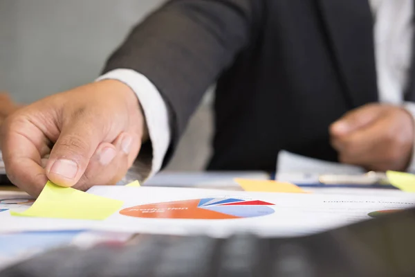 young successful man holding sticky note paper on meeting in mod