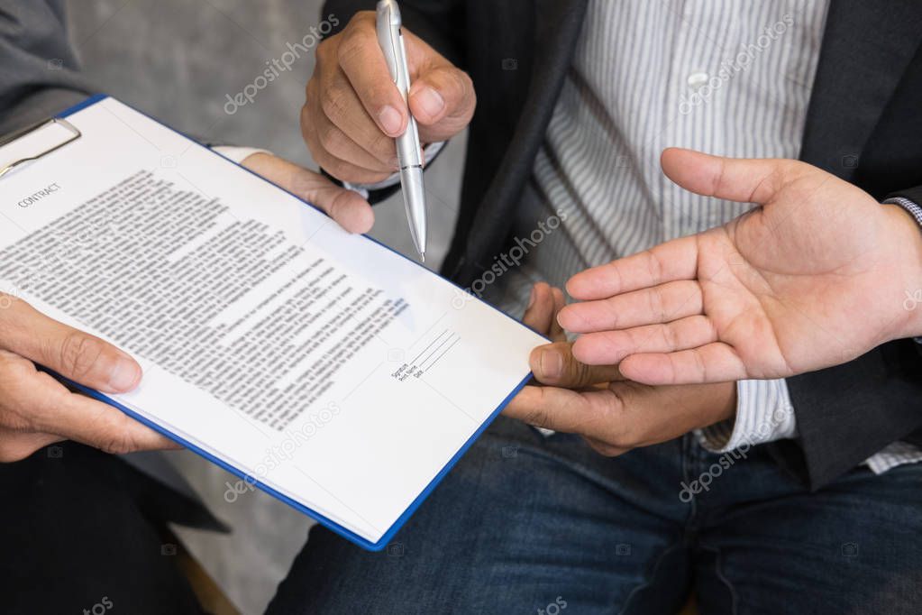 Businessman and lawyer negotiating a contract, they are pointing