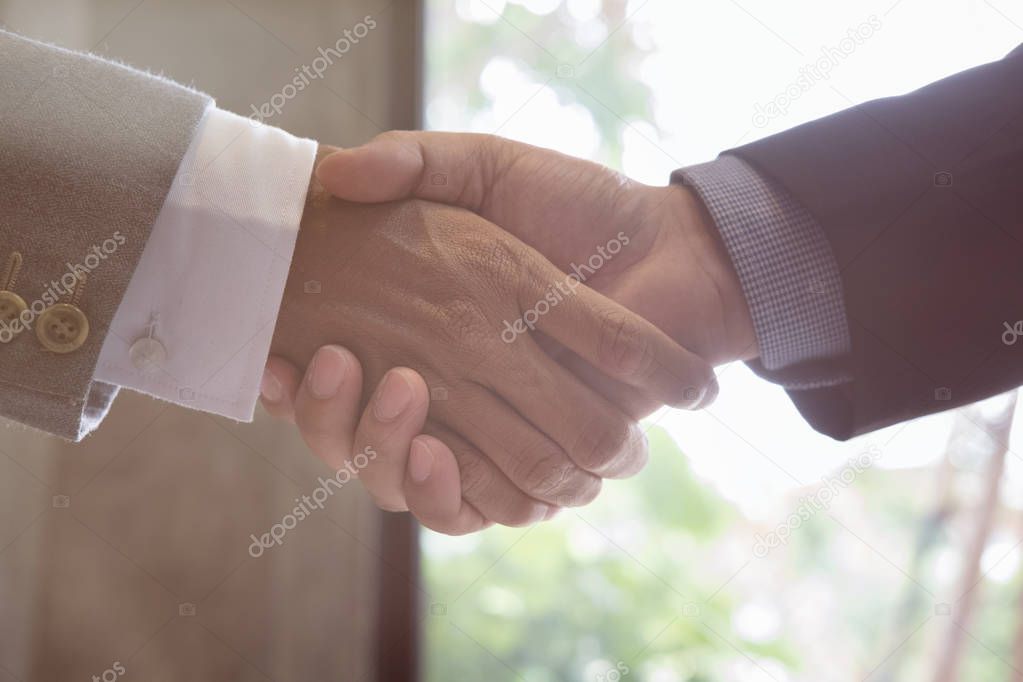 Business people shaking hands after finishing up a meeting. Busi