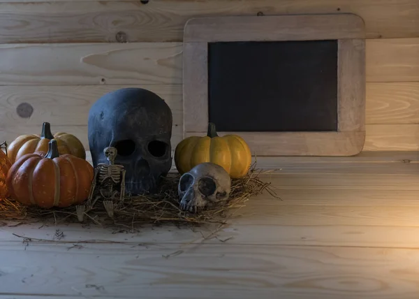 Pumpkin, skull, skeleton on wooden background for Halloween holi — Stock Photo, Image