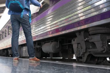 tren istasyonunda platformda ayakta sırt çantası olan Asya adam. b