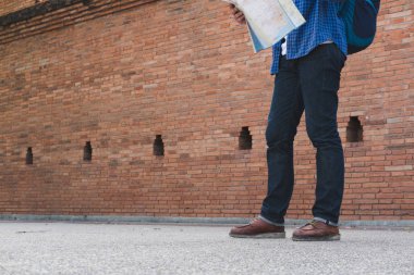 Genç Gezgin okuma harita. Asya adam mavi gömlek ve jea