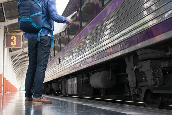 Asiático hombre con mochila de pie en la plataforma en la estación de tren. b) — Foto de Stock