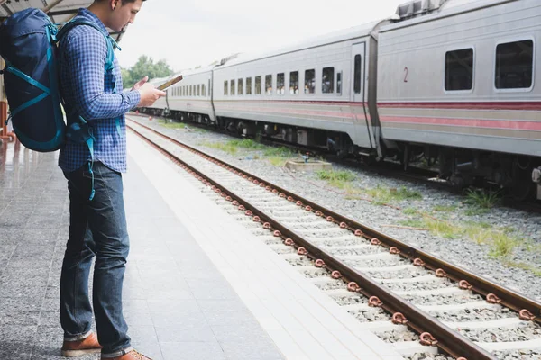 tren istasyonunda platformda ayakta sırt çantası olan Asya adam. b