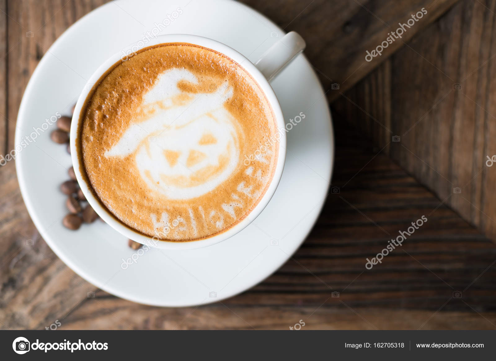 Halloween latte art on hot cappuccino coffee in white mug on woo Stock