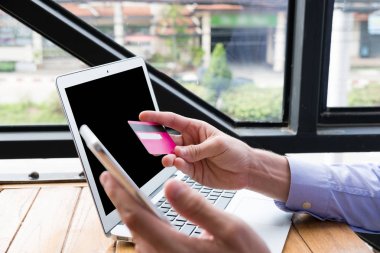 kredi kartı ve akıllı telefon ofiste holding iş adamı. adam pur