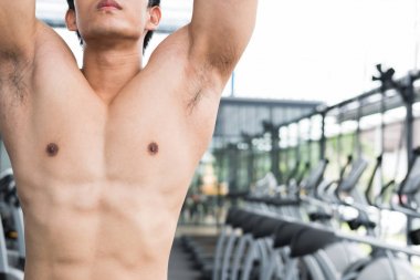 genç adam ile makine fitness merkezinde egzersiz yürütmek. Erkek 