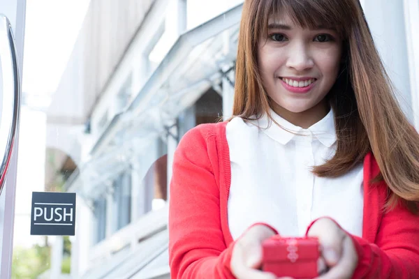 Vrouw met geschenkdoos. Aziatische vrouw dragen witte shirt en rode kn — Stockfoto