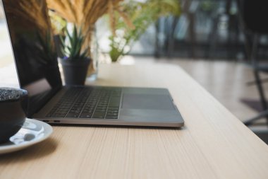bilgisayar, kahve Kupası ahşap masa üzerinde. Ofis İşyeri dizüstü.