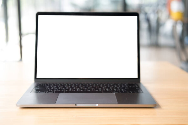 computer on wood desk. laptop with blank screen at office workpl