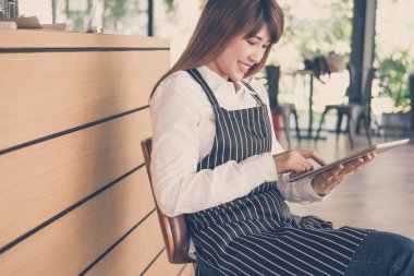 kahve dükkanında kasaya tablet tutan küçük işletme sahibi. f