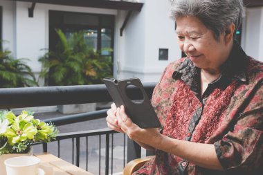 cep telefonu kafede tutan yaşlı kadın. yaşlı kadın manifatura