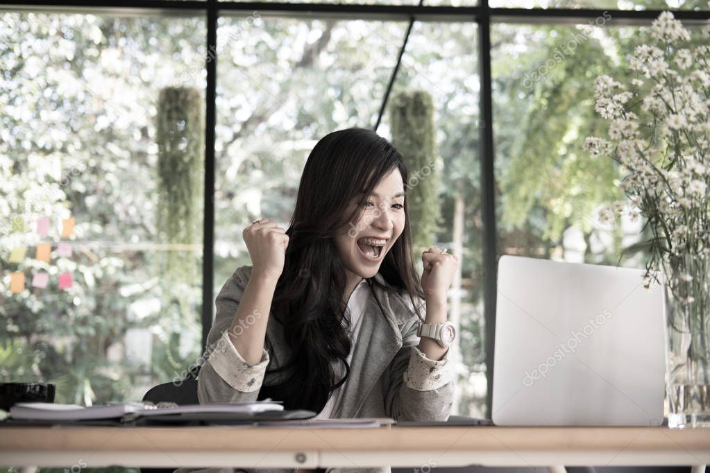 start up woman raise fist with yes gesture at office. freelance 