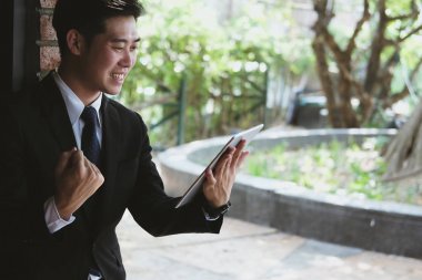 Başarılı iş adamı kontrol mesaj tablet ve yumruk zekâ yükseltmek